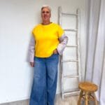 Gele sweater met jacquard mouwen